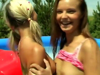 Lesbians have fun with a dildo at pool party