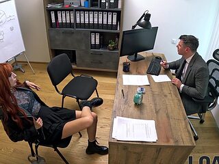 Redhead Lilly Mays fucks with her boyfriend in a steamy office scene.