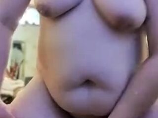 A mature plump girl is bouncing on a rubber dick