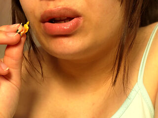 Giantess Girl Unwraps a Candy but Is Surprised Because There Is a Tiny Man in the Candy Bag - She Is Curious to See What It