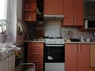 A Sexy Naked Woman Prepares Food in the Kitchen
