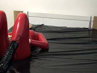 Photoshooting in Red Latex Catsuit with Latex Mask and Transparent Face.