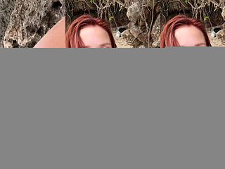 Redhead beauty plays with herself on a secluded beach