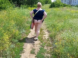 A fat woman walks through the park shows her ass and masturbates