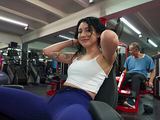 Tattooed MILF sucks cock and rides reverse on gym floor