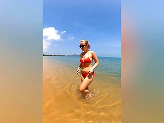 A sexy girl Lovita Fate playing on the beach in a bikini