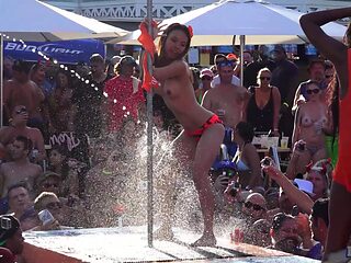 Mature Blondie flaunts her fakes in a skimpy bikini at the beach